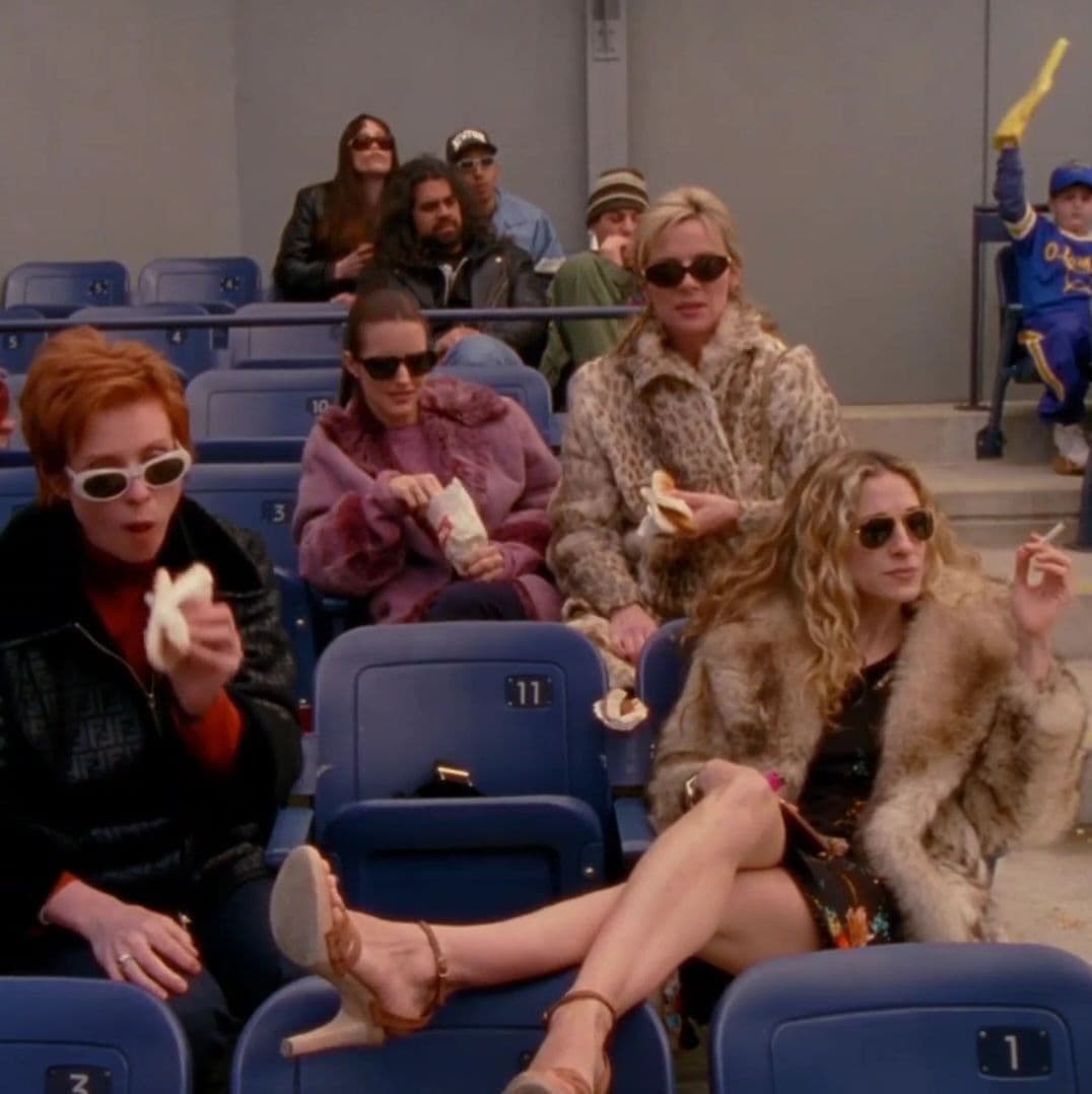 Three of the characters at a baseball game in fur coats.